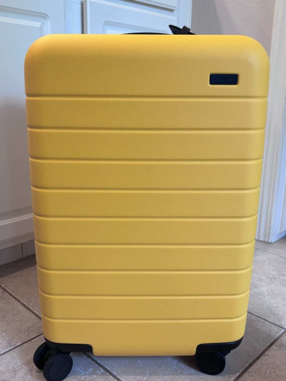 Away Yellow Bigger Carry-On with removable USB charger/power bank.